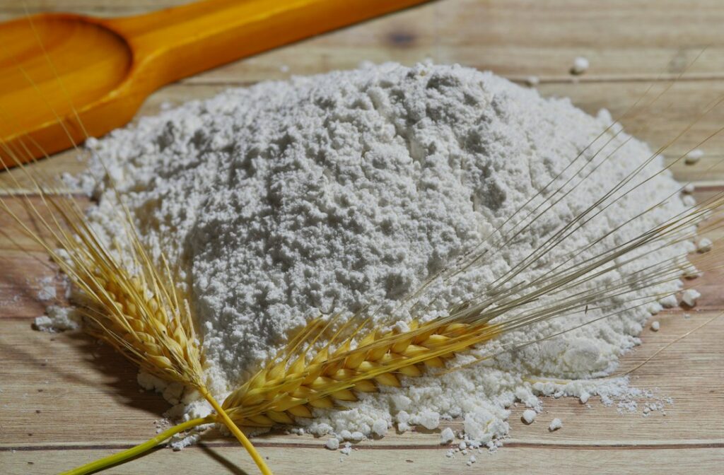 White flour and wheat, illustrating refined flour and whole-grain choices.